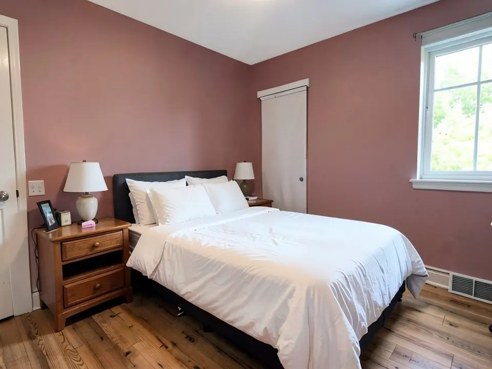 The same bedroom with the walls painted a dusty rose pink