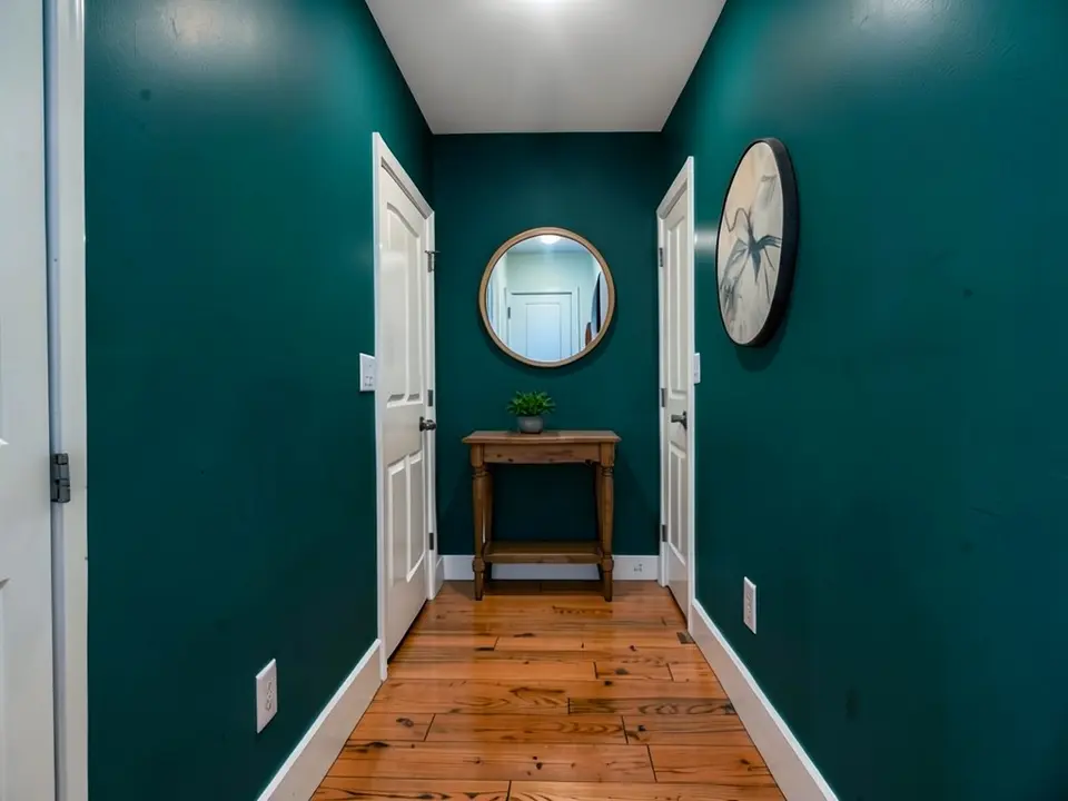 The same hallway with the walls painted a deep teal