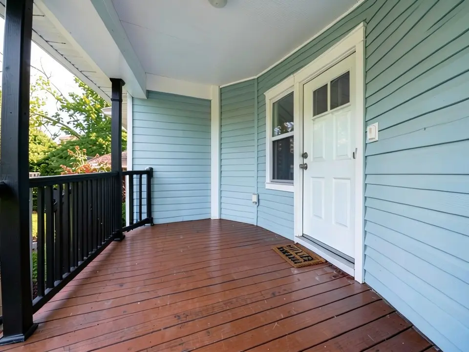 The same porch with the railings and posts painted black
