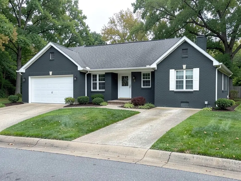 The same ranch house with the brick painted dark charcoal gray and white trim kept