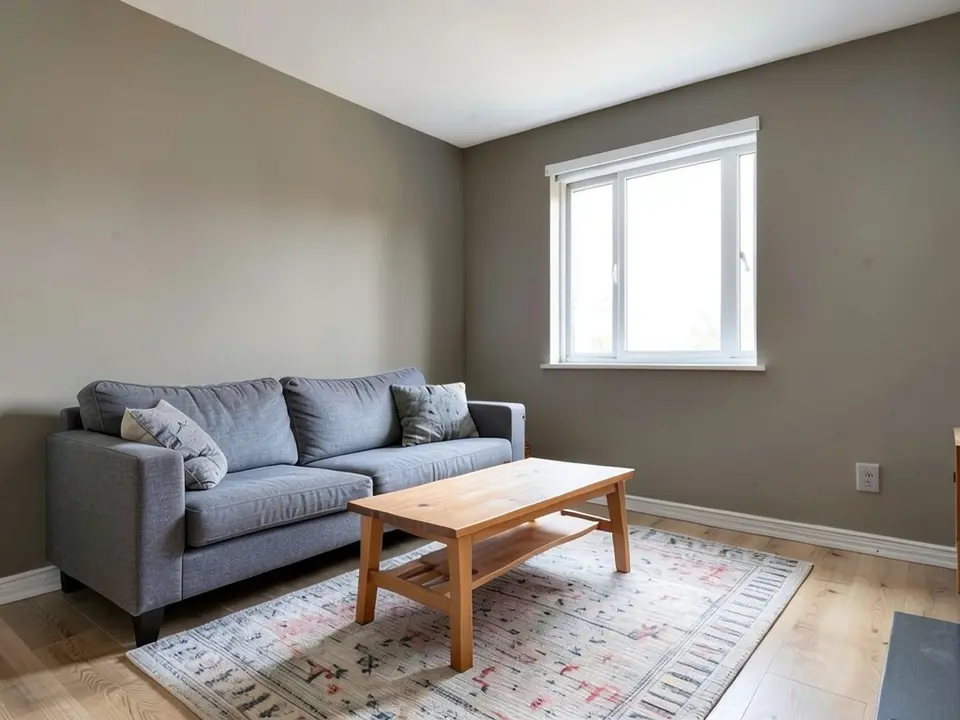 The same living room with the walls painted a warm gray-beige